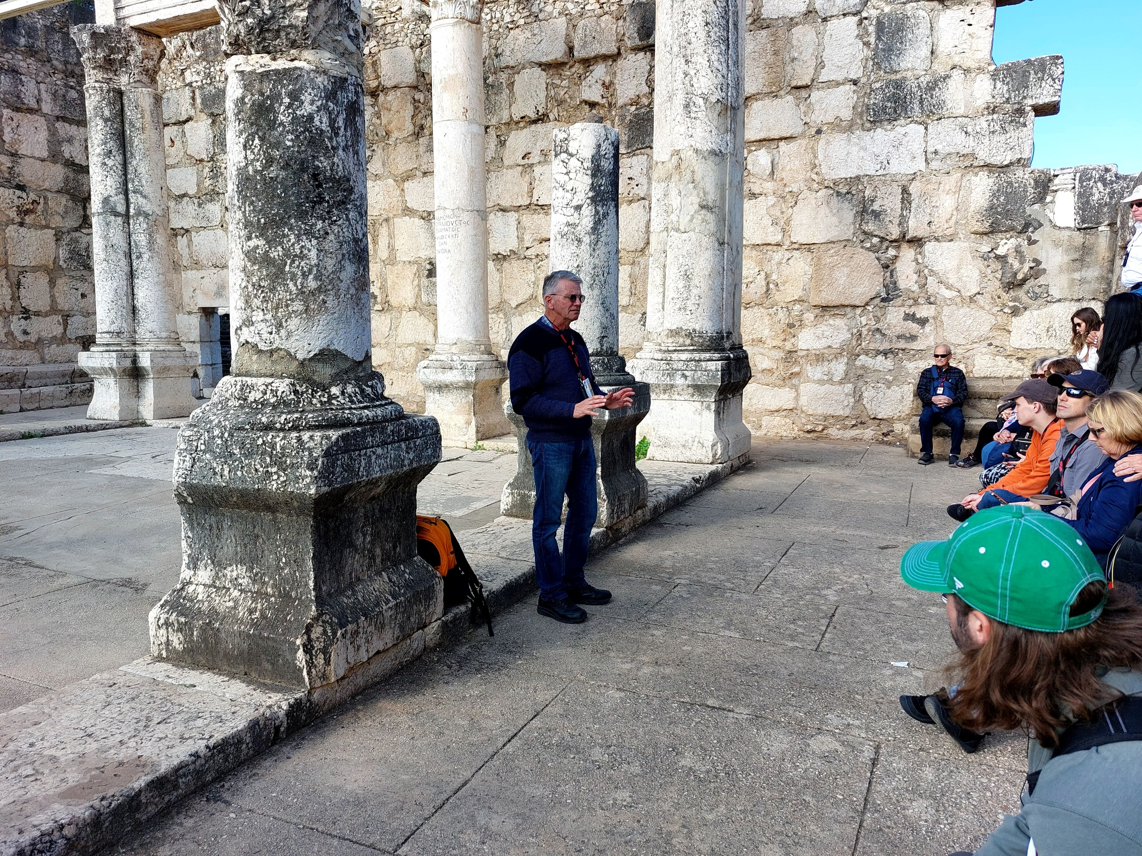 Tour guide Stan speaking to a group at the Capernaum synagogue ruins