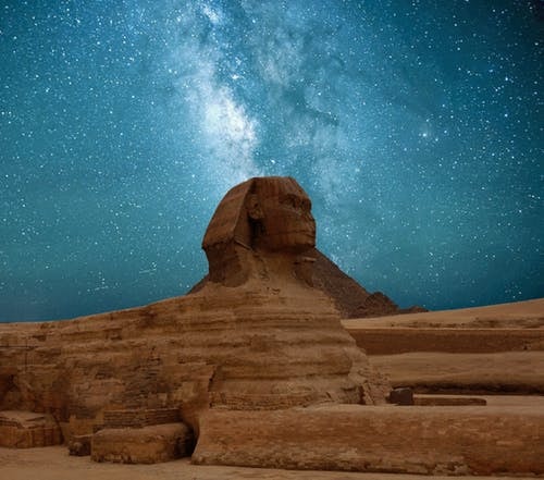 The Great Sphinx under a starry night sky with the Milky Way