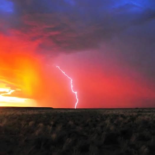 Lightning strike at sunset over open plains