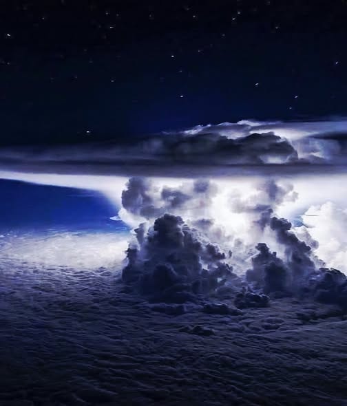 Storm in the upper atmosphere viewed from above the clouds at night