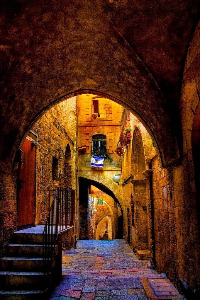 Ancient stone archway passage in Jerusalem with warm golden light