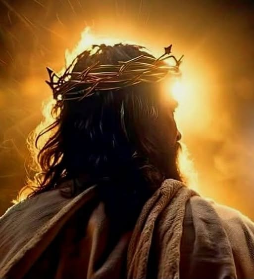 Jesus with crown of thorns silhouetted against a blazing golden light