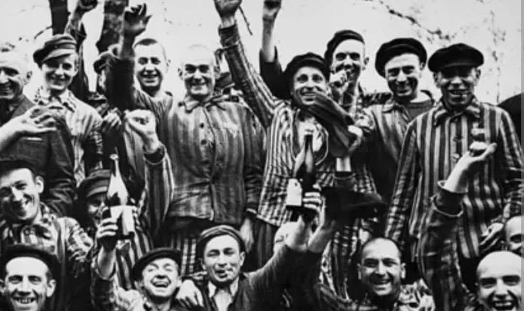 Liberated prisoners at Dachau Concentration Camp celebrating their freedom, April 1945