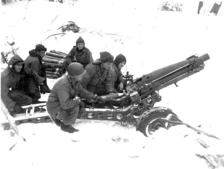 Artillery crew manning their gun in the snow during the Vosges Mountains campaign